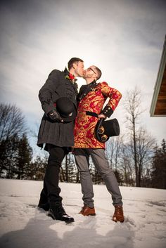 two people are standing in the snow kissing