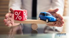 a toy car is on top of a wooden block with a percentage sign in front of it