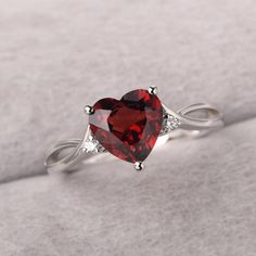 ◆ The ring is handcrafted from sterling silver and decorated with a dazzling 8*8 mm garnet and CZs. It is suitable for engagement/anniversary/daily occasion. ◆ Production Description: Main stone Type: Natural Garnet Main Stone Shape: Heart Cut Main Stone Size: 8*8 mm(2.44ct) Side stone: CZ Metal: 925 Sterling silver - Other options available in the drop down menu ◆ Customization: √Free for Add Engraving √Other Metal Type Available √Other Gemstones & Shapes Available √Personalization Requests Ava Garnet Birthstone Promise Ring In Fine Jewelry Style, Garnet Center Stone Birthstone Ring, Garnet Birthstone Ring With Accent Stones, Silver Birthstone Ring With Prong Setting For Valentine's Day, Gift Rings With Center Stone And Lab-created Ruby, Silver Birthstone Ring For Valentine's Day, Garnet Rings With Accent Stones As Gift, Gift Ring With Lab-created Ruby Center Stone, Gift Rings With Lab-created Ruby Center Stone