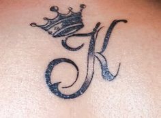 a tattoo with the letter k and a crown on it