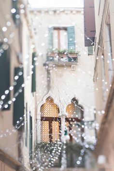 an alleyway with lights and windows on both sides