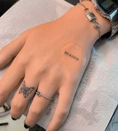 a woman's hand with a tattoo on it and the words be good written on her wrist