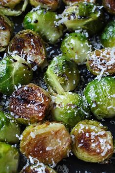 brussel sprouts with parmesan cheese on top in a skillet