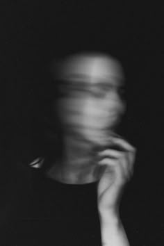 a blurry image of a person's face in the dark