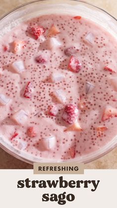 a smoothie with strawberries is in a glass bowl