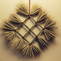 an ornament made out of straws on a wall