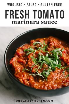 fresh tomato marinara in a black bowl on a white marble countertop with the words fresh tomato marinara