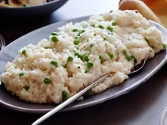 a plate with mashed potatoes and peas on it