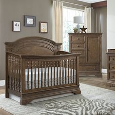 a baby crib and dresser in a room