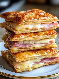 a stack of pancakes with ham and cheese