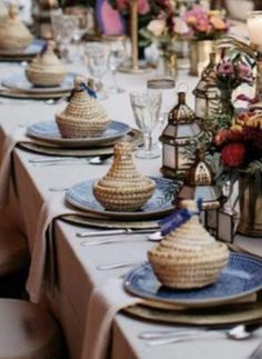 the table is set with dishes and place settings