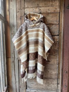 Alpaca/lambswool mix poncho hooded Brown lambswool/alpaca wool poncho Etno style wool poncho very warm and breathable Blanket poncho One size fits fashionably for most everyone, short or tall, big or small. This piece is versatile for both Men's & Women's outdoor fashion, and can be used insider in cooler winter weather to keep warm while reading on the couch. CARE: Hand-wash and hang to dry, light iron if needed, or dry clean. MEASURES: Length at the front of the neckline to the bottom is ~100 Brown Alpaca Poncho For Winter, Bohemian Alpaca Cape For Fall, Cozy Brown Alpaca Poncho, Brown Wool Bohemian Shawl, Bohemian Alpaca Shawl For Fall, Cozy Brown Wool Poncho, Handwoven Wool Poncho For Fall, Handwoven Alpaca Poncho For Fall, Fall Handwoven Alpaca Poncho