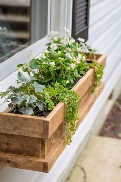 a window sill filled with plants on the side of a house