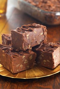 four pieces of chocolate fudge on a gold plate