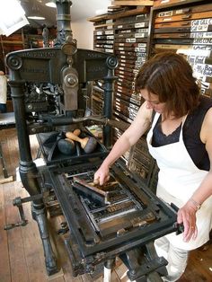 a woman working on an old fashioned stove