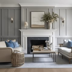 a living room filled with furniture and a fire place in front of a painting on the wall