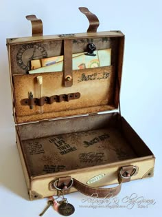 an open suitcase with writing on it and keys in the bottom compartment that are attached to each other