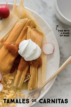 tamales de carnitas on a plate with sour cream and radishes