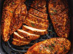 sliced pork on a grill with herbs and seasoning in the middle, ready to be grilled