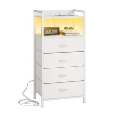 a white cabinet with three drawers and a light on it's side, in front of a white background