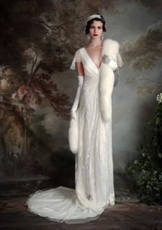 a woman in a white dress and fur stole