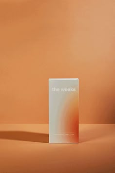 an orange and white box with the words the weaks on it sitting on a table