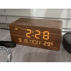 a wooden clock with the time displayed on it