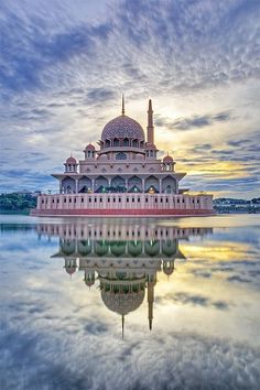 an image of a mosque in the middle of water with a sky background and clouds above it