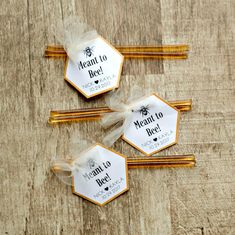 three honey combs with labels on them sitting on a wooden table next to some chopsticks