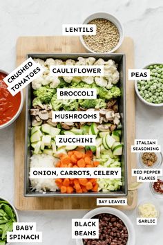 an overhead view of the ingredients for a healthy meal including broccoli, cauliflower, zucchini, carrots, beans and peas