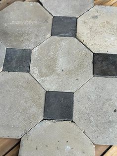 some black and white tiles on a wooden floor