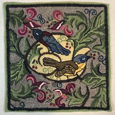 two birds sitting on top of a rug