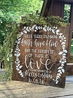 a wooden sign that says, these three remain both hope and love but the greatest love is love