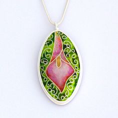 Handmade pink calla lily cloisonne enamel pendant necklace with various shades of green in the background. Set in fine silver. Hand Painted Silver Jewelry As Gift, Hand Painted White Sterling Silver Jewelry, Unique Hand Painted Sterling Silver Jewelry, Unique Hand Painted Silver Jewelry, Sterling Silver Teardrop Jewelry With Artistic Design, Artistic Enamel Jewelry As A Gift, Hand Painted Enamel Jewelry, Hand Painted Enamel Jewelry For Gifts, Elegant Hand Painted Silver Jewelry