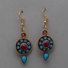 Tibetan Buddhist Set of Earrings About our product: The Tibetan Buddhist Set of Earrings is a finely designed pair of earrings that perfectly captures traditional Tibetan handicrafts' great artistic skill and spiritual legacy. These gorgeous earrings, crafted from copper and beautifully plated in electro gold, have semi-precious stones like ruby and turquoise that add to their visual and spiritual appeal. Tibetan jewelry is known for its ageless beauty and profound cultural importance, reflected Nepal Fashion, Tibetan Jewelry, Ageless Beauty, Tibetan Buddhist, Girly Jewelry, Copper Earrings, Ethnic Jewelry, Gorgeous Earrings, Semi Precious Stones