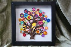 a tree made out of buttons in a shadow box