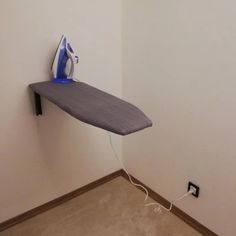 an ironing board is plugged into the wall