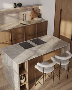 a kitchen counter with two stools next to it and an island in the middle