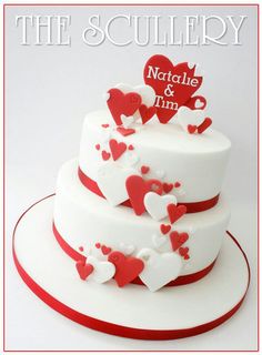 a three tiered white cake with red hearts on the top and bottom layer that reads, the sculleryy