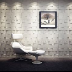 a white chair and ottoman in front of a wall with a painting on the wall