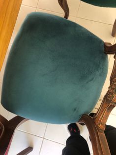 a blue chair sitting on top of a white tiled floor