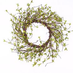 a twig wreath with green leaves on a white background