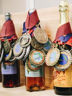 three bottles of wine with medals hanging from them