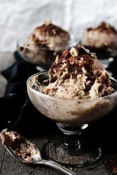 two bowls filled with ice cream on top of a wooden table