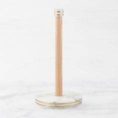 a wooden toothbrush holder sitting on top of a marble counter