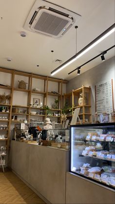 the inside of a bakery with shelves and counters