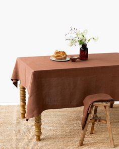 a table with a plate of food on it and a bottle of wine next to it