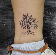 a small tree tattoo on the ankle