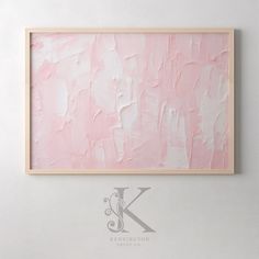 a pink painting hanging on the wall