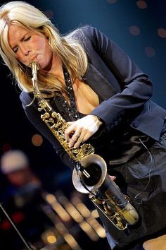 a woman playing a saxophone on stage